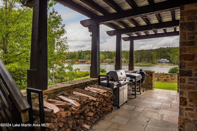 view of patio / terrace with a water view and grilling area