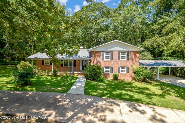 605 Noble Rd, Tallassee, AL 36078 - tri-level home featuring brick siding, a front lawn, and covered porch
