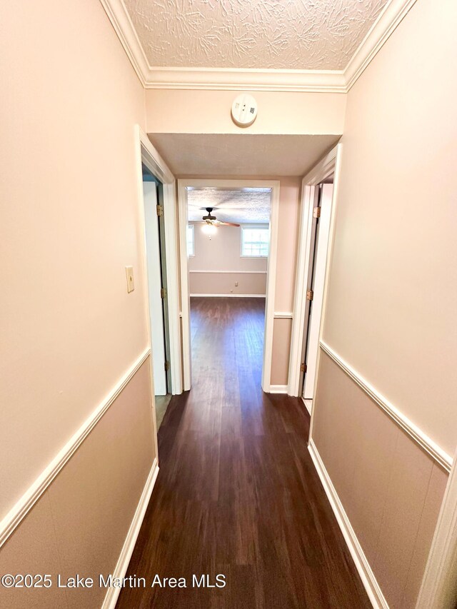 605 Noble Rd, Tallassee, AL 36078 - hall featuring baseboards, crown molding, wood finished floors, and a textured ceiling