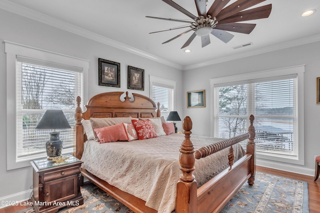 bedroom with hardwood / wood-style flooring, ceiling fan, and crown molding