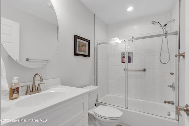 full bathroom with toilet, vanity, and shower / bath combination with glass door