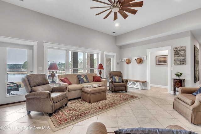 living room featuring light tile patterned floors and ceiling fan