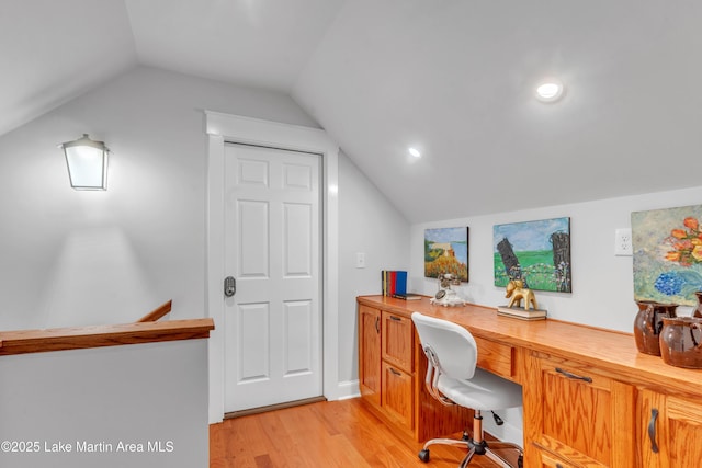 office with lofted ceiling and light hardwood / wood-style floors