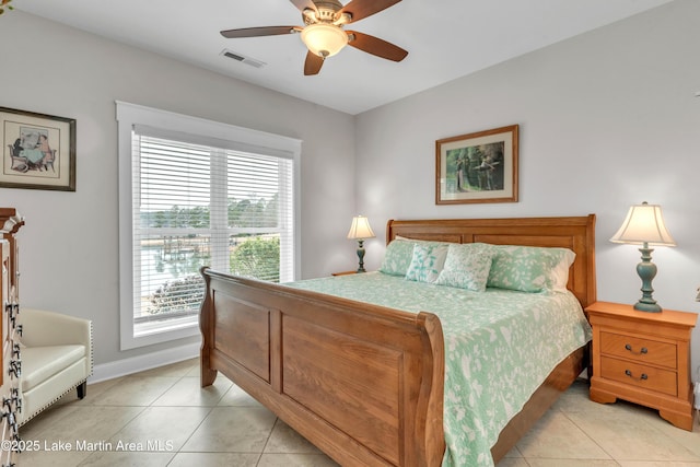 tiled bedroom featuring ceiling fan