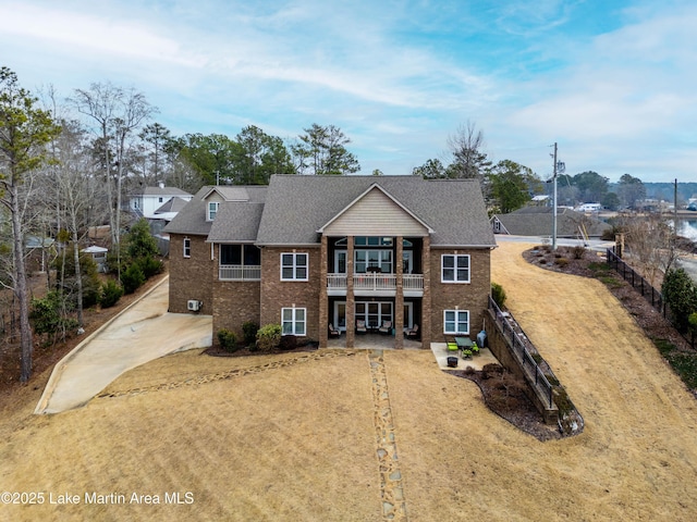 view of front of home with a front yard and a balcony