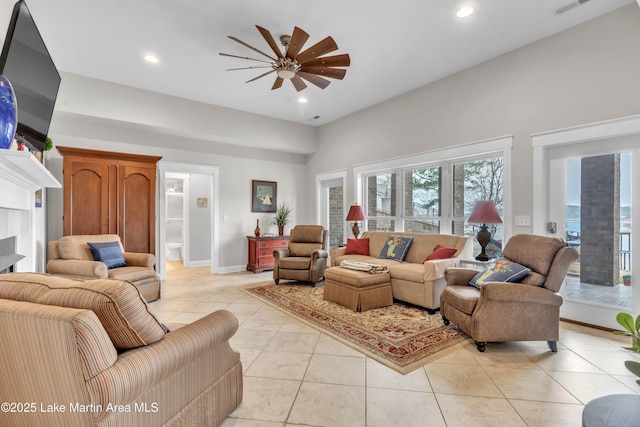 living room featuring ceiling fan and light tile patterned floors