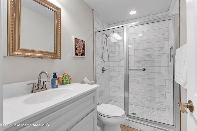 bathroom featuring vanity, toilet, and walk in shower