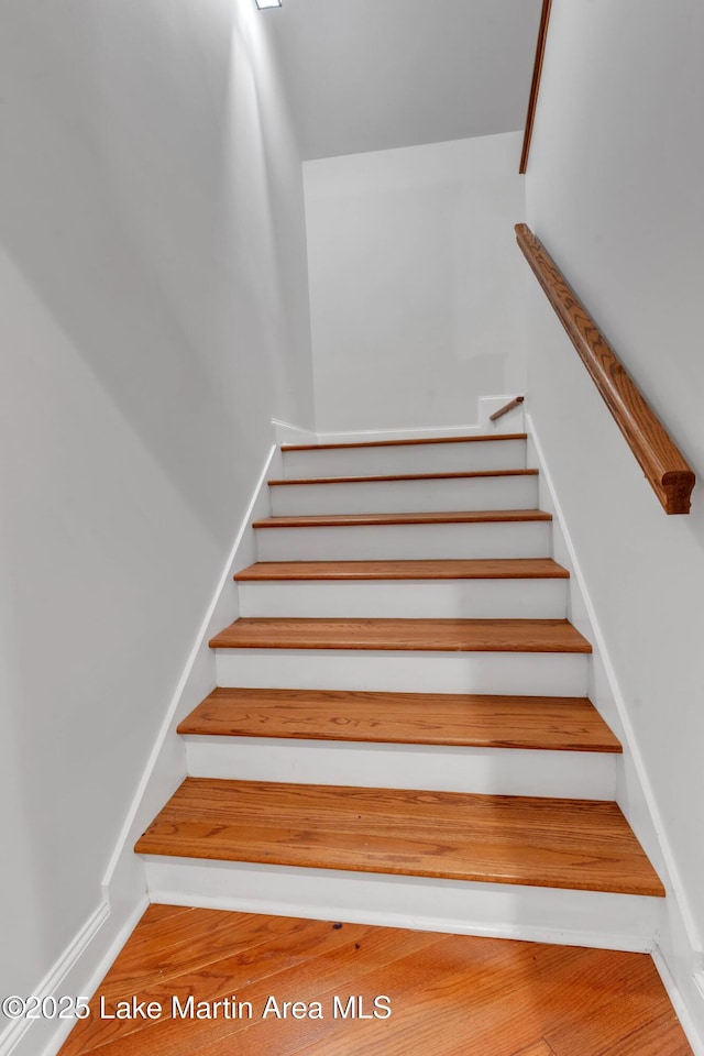 staircase featuring hardwood / wood-style floors