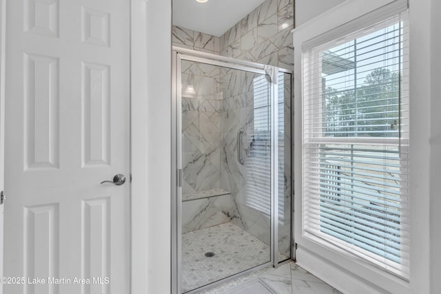 bathroom featuring a shower with door