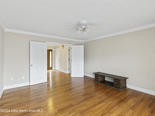 spare room featuring crown molding, ceiling fan, and wood-type flooring