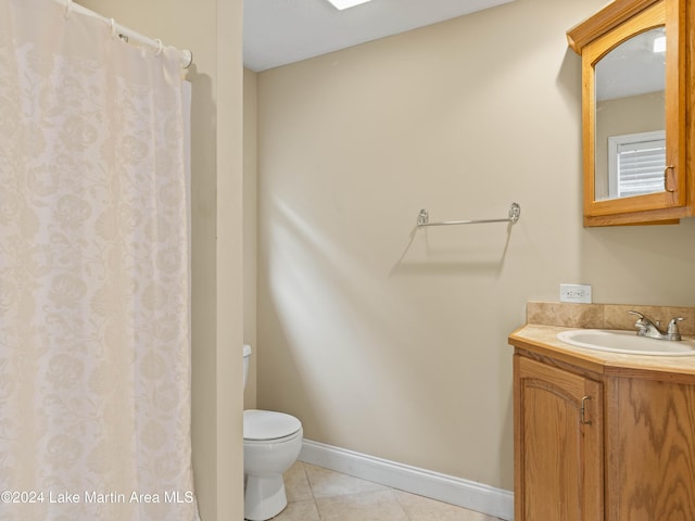 bathroom featuring tile patterned flooring, vanity, and toilet