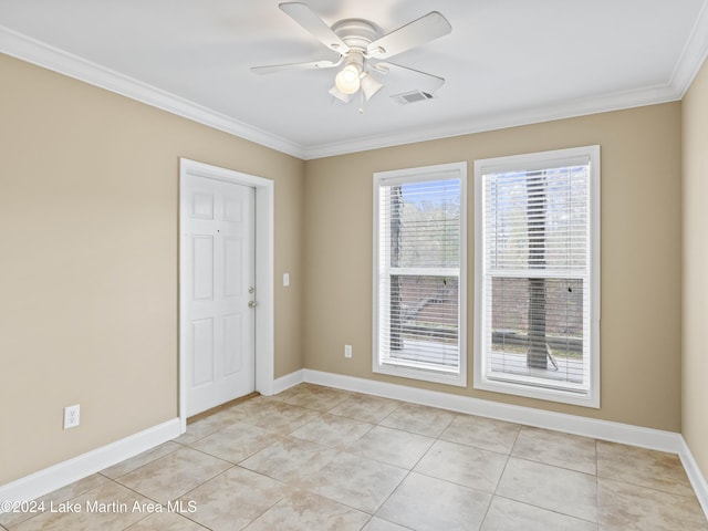 tiled spare room with ceiling fan and crown molding