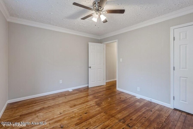 empty room featuring hardwood / wood-style flooring, ceiling fan, crown molding, and a textured ceiling