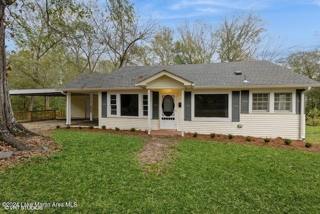 view of front of property with a front yard and a carport