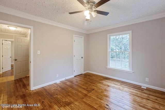 unfurnished bedroom featuring hardwood / wood-style floors, ceiling fan, and crown molding