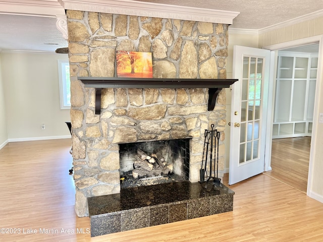 room details featuring hardwood / wood-style floors, ornamental molding, a fireplace, and a textured ceiling