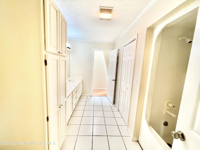 bathroom with tile patterned flooring, vanity, and ornamental molding