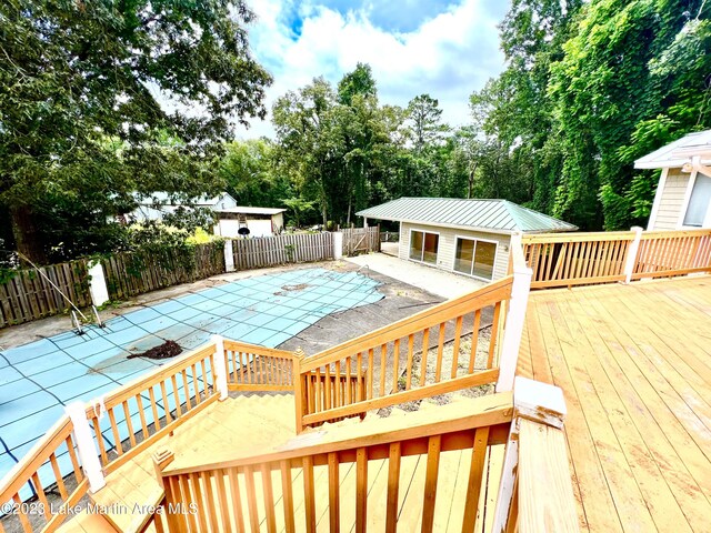 view of pool with a patio and a deck