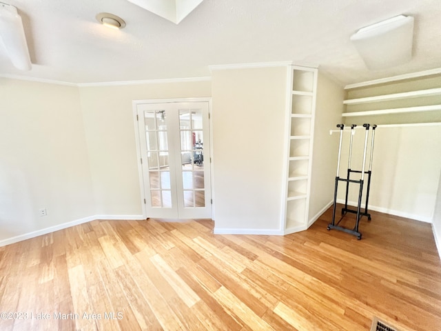 unfurnished room with hardwood / wood-style floors, ornamental molding, and french doors