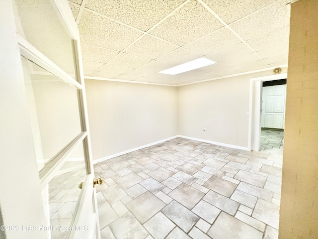 basement featuring a paneled ceiling