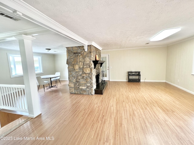 unfurnished living room with a fireplace, crown molding, hardwood / wood-style floors, and a textured ceiling