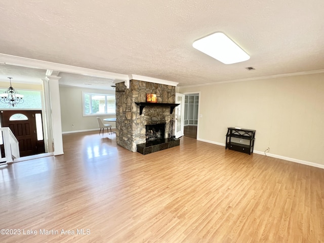 unfurnished living room with a fireplace, crown molding, hardwood / wood-style floors, and a textured ceiling