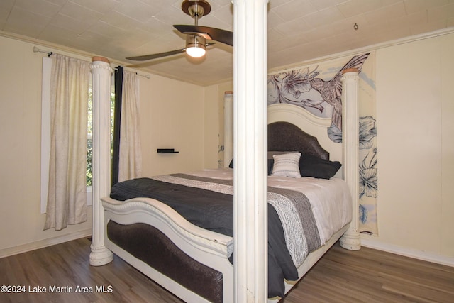 bedroom featuring ceiling fan, dark wood-type flooring, and ornamental molding