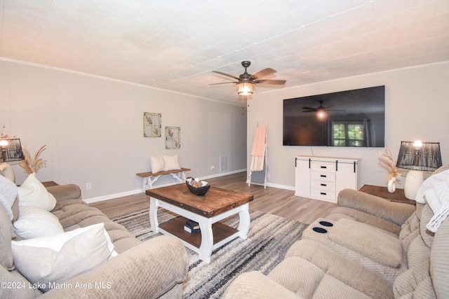 living room featuring crown molding, ceiling fan, and light hardwood / wood-style floors