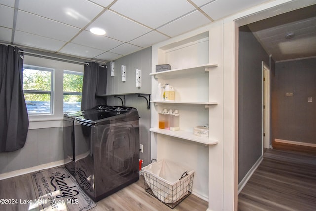 washroom with hardwood / wood-style floors and washer and dryer