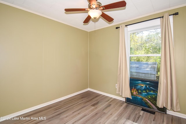 spare room with hardwood / wood-style floors, ceiling fan, and ornamental molding