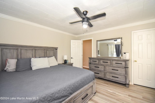 bedroom featuring ceiling fan, light wood-type flooring, and crown molding