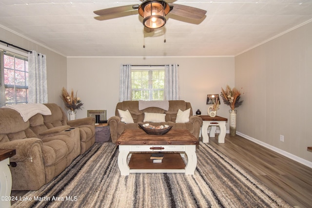 living room featuring a wealth of natural light, ceiling fan, ornamental molding, and hardwood / wood-style flooring