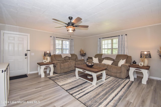 living room featuring ceiling fan, crown molding, a healthy amount of sunlight, and light hardwood / wood-style floors