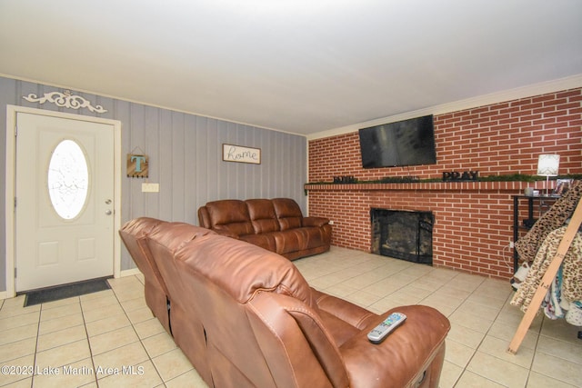 living room featuring light tile patterned floors, crown molding, and a brick fireplace