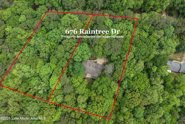 birds eye view of property with a view of trees