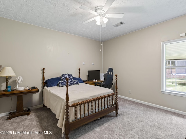 carpeted bedroom featuring ceiling fan, a textured ceiling, baseboards, and visible vents
