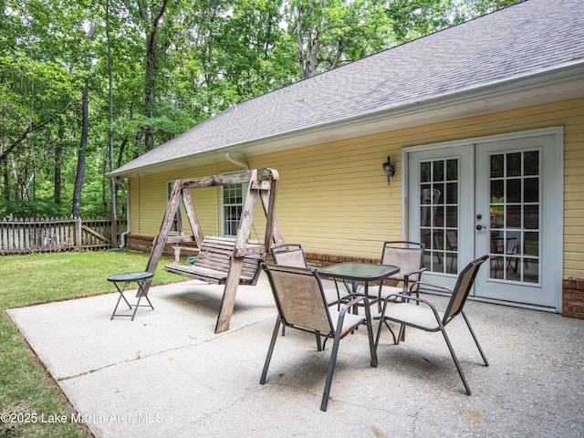 view of patio / terrace featuring fence and french doors