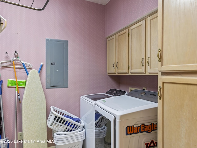 clothes washing area with electric panel, washing machine and dryer, cabinet space, and wallpapered walls