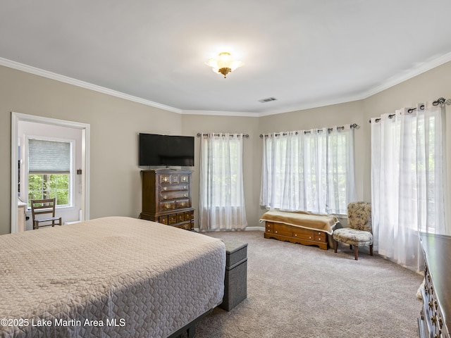 carpeted bedroom featuring ornamental molding and visible vents