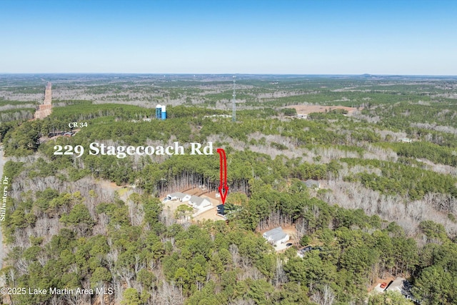 birds eye view of property featuring a wooded view