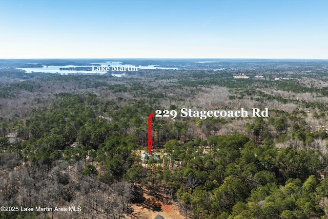 birds eye view of property featuring a view of trees