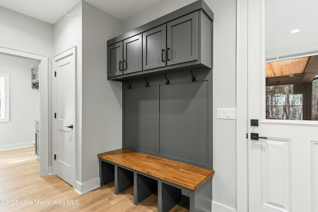 mudroom featuring baseboards and light wood finished floors