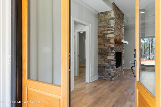 hall with baseboards and wood finished floors