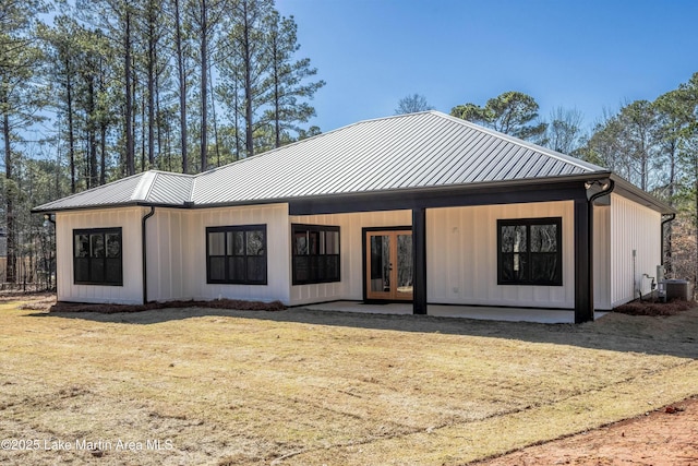 back of house with board and batten siding, french doors, metal roof, and a standing seam roof