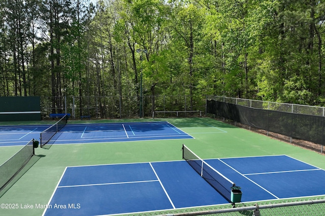 view of tennis court with fence