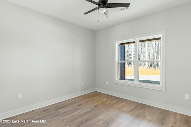 unfurnished room with light wood-type flooring, baseboards, visible vents, and ceiling fan