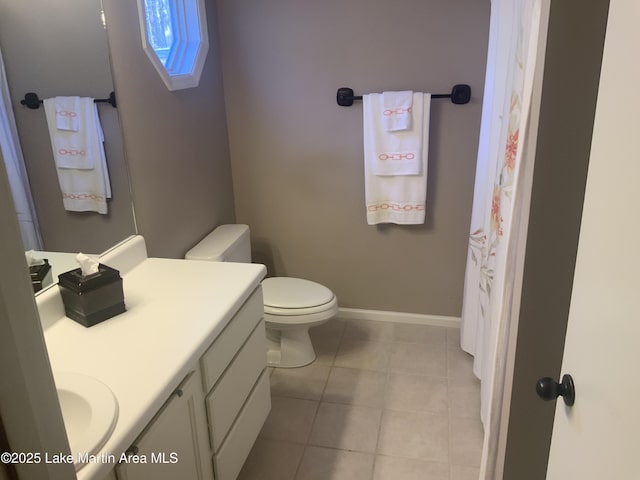 bathroom with vanity, toilet, and tile patterned flooring