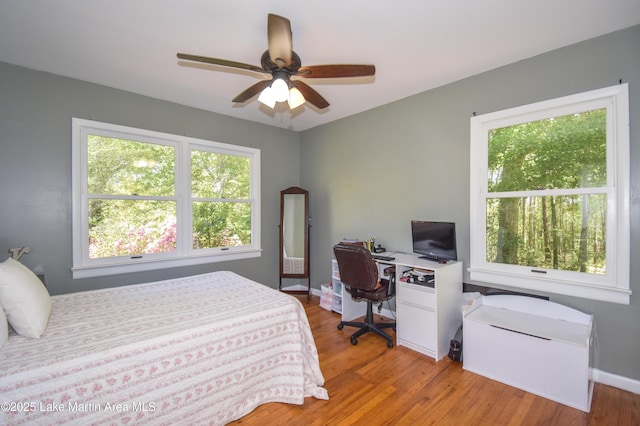 bedroom featuring baseboards, a ceiling fan, and wood finished floors