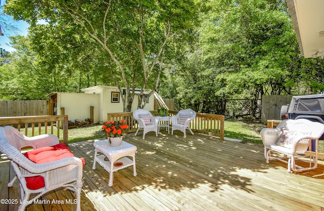 deck featuring a fenced backyard and an outdoor structure