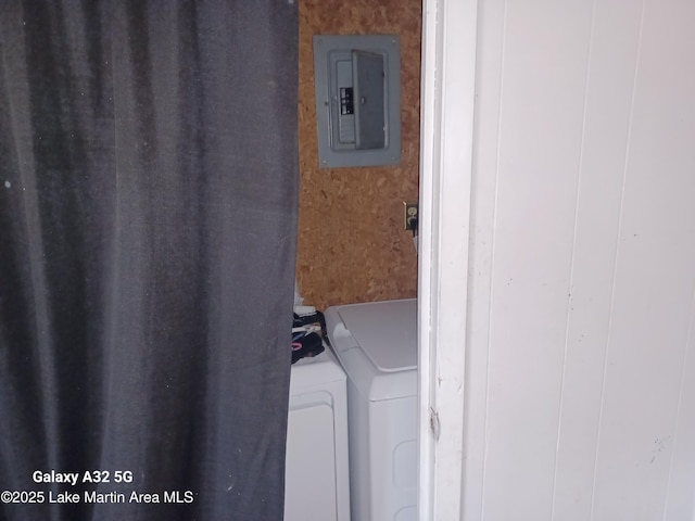 laundry room with washing machine and dryer, electric panel, and laundry area